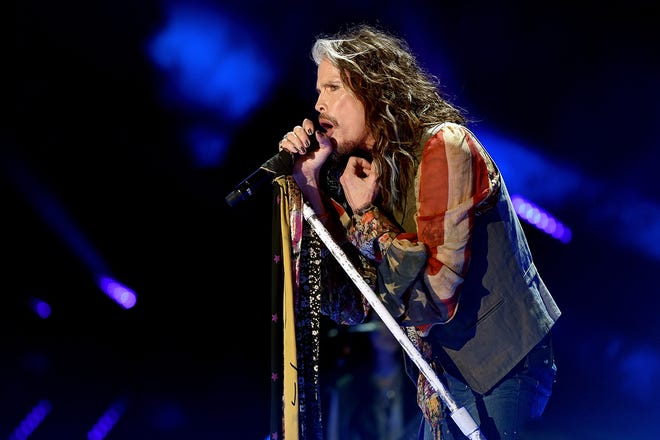 Steven Tyler performs at the 2016 CMA Music Festival in an American flag-themed shirt.