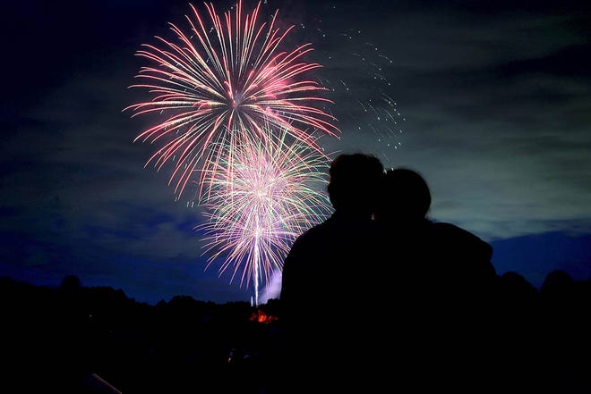 A young couple joined hundreds of others for the Monday evening 4th of July fireworks display at Deerfield Park in Smithfield on July 2, 2024.