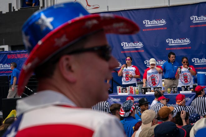 Competitors compete for the women's title at Nathan's Annual Hot Dog Eating Contest on July 4, 2024 in New York City.