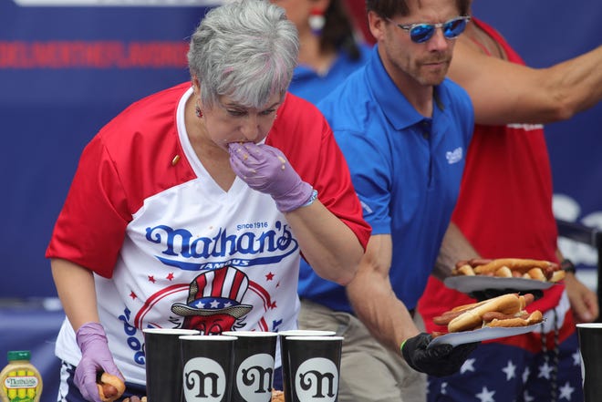 A competitor competes for the women's title of the 2024 Nathan's Famous Fourth of July hot dog eating competition at Coney Island in the Brooklyn borough of New York on July 4, 2024.