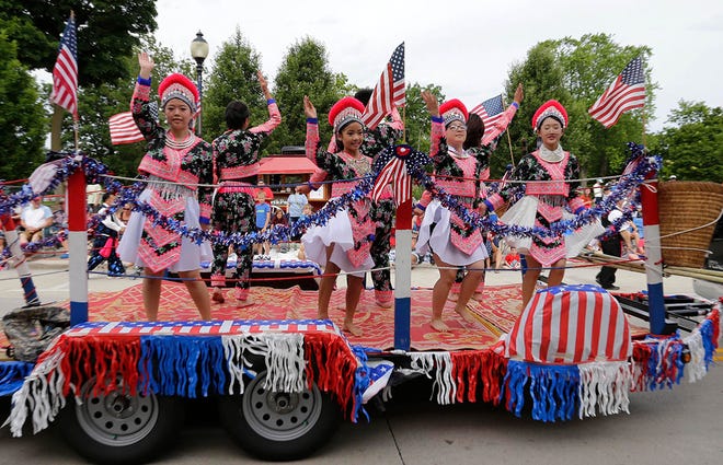 Members of Sheboygan’s Hmong community dance during the Fourth of July parade, Thursday, July 4, 2024, in Sheboygan, Wis.