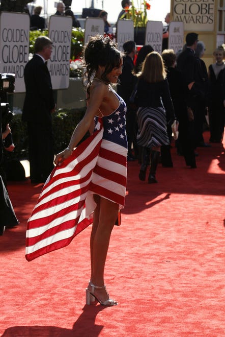 Cynthia Garret shows her flag dress on the red carpet as she arrives at the 59th annual Golden Globe Awards in 2002.